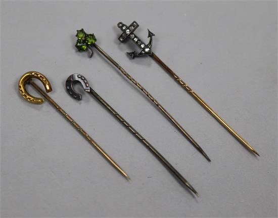 Four assorted tiepins including a diamond set anchor.